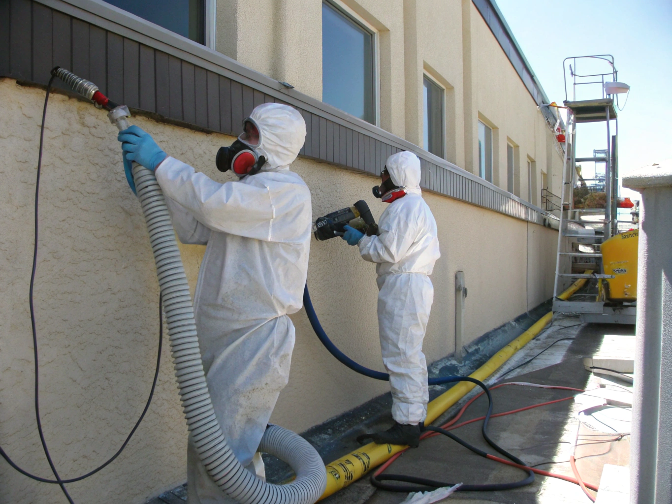 Industrial lead abatement worker using HEPA containment apparatus